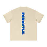 Back view of beige Mets Blue T-Shirt - Heavyweight Earth Tone with vertical blue FNDMTLS logo. Heavyweight cotton casual wear.