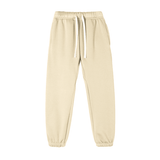 Essential Fleece Sweatpants in cream color with side pockets and adjustable drawstring, designed for unisex comfort and style.