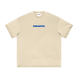 Flat lay of beige Mets Blue T-Shirt - Heavyweight Earth Tone with blue FNDMTLS logo on front. Premium cotton unisex streetwear.