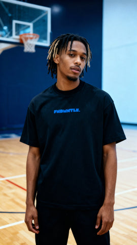 Black version of Mets Blue T-Shirt - Heavyweight Earth Tone with blue FNDMTLS logo, worn on basketball court. Unisex cotton streetwear.
