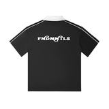 Back view of black short-sleeve polo shirt featuring contrast collar and bold 'FNDMNTLS' text across the shoulders.