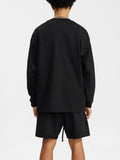 God Fndmntls Long Sleeve Crest Shirt in black with shorts outfit, perfect for casual wear