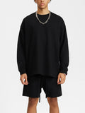 Black sweatshirt and shorts set showcasing the God Fndmntls Long Sleeve Crest Shirt in inch and cm sizes