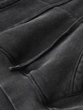 Close-up of a snow washed cropped hoodie pocket showcasing grey fabric in inch measurements
