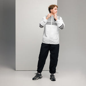 Man in white and black athletic wear with breathable mesh lining for Ferrari Boys water-resistant fabric