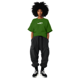 Woman wearing Angel Wings Fndmntls Green Graphic Tee and black pants showcasing angel wings design