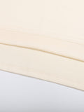 Detailed view of hem stitching on beige Mark the Believer Tee. Durable 100% cotton fabric for long-lasting casual wear.