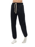 Model posing in black Essential Fleece Sweatpants, demonstrating flexible movement and stylish fit for unisex activewear.