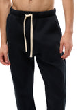 Close-up of black Essential Fleece Sweatpants waistband and drawstring, emphasizing soft fleece texture and adjustable fit.