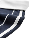 Close-up of white shoulder stripe and seam detail on navy short-sleeve polo shirt with contrast collar.