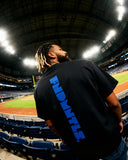 Side view of black Mets Blue T-Shirt - Heavyweight Earth Tone with vertical FNDMTLS logo. Perfect for casual and sporty looks.