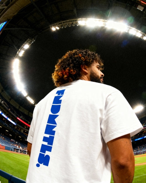 Back view of Mets Blue T-Shirt - Heavyweight Earth Tone in white, featuring vertical FNDMTLS logo. Ideal for casual wear and street style.