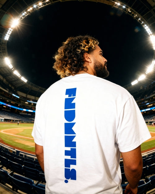 Vertical FNDMTLS logo on back of Mets Blue T-Shirt - Heavyweight Earth Tone in white. Unisex cotton tee perfect for casual outings.