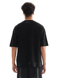 Back view of a person wearing a black Rositas Butterfly Hand Brushed Graphic T-shirt made of soft cotton with a relaxed fit.